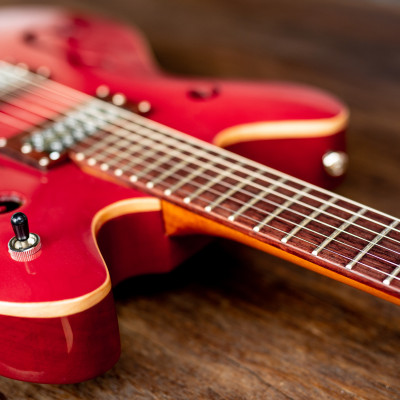 red electric guitar wooden floor